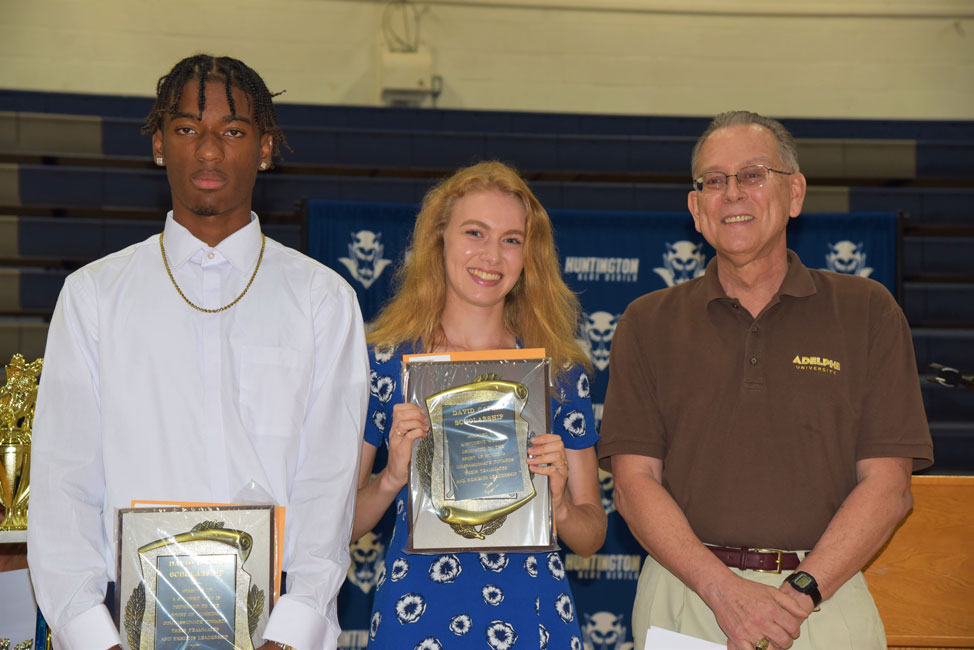 David Caplin Memorial Scholarship Award recipients Johnathan Smith and Hadley Clayton with Class of 1974 member Tim Seymour 