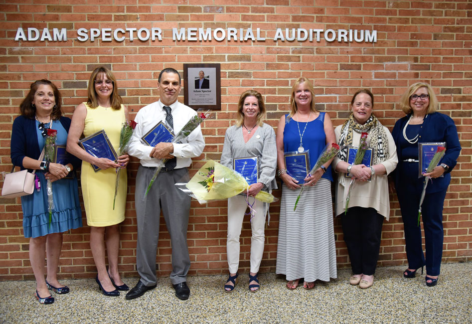 Retiring Huntington School Board Vice President Bari Fehrs is flanked by departing faculty and staff members earlier this week 