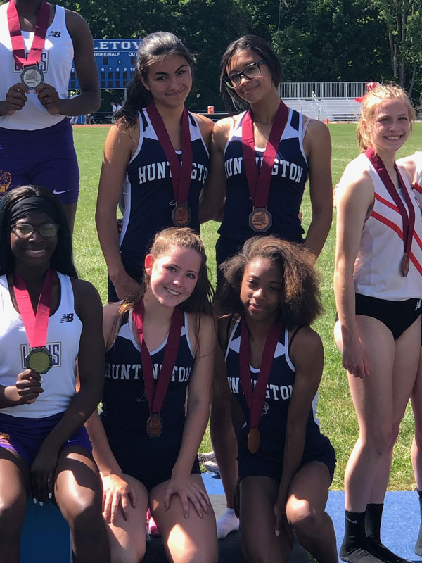The Huntington girls' 4x400m relay with their medals on the State Federation victory stand. 