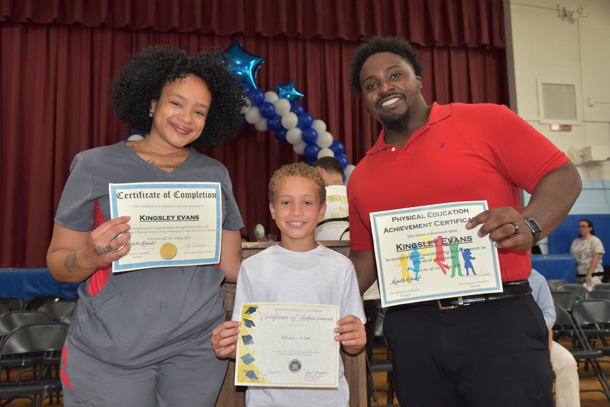 Washington third grader Kingsley Evans with his family at the moving up exercises 