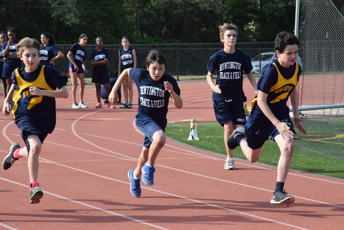 Chris Engle (center) sprinting for the Finley track and field team.