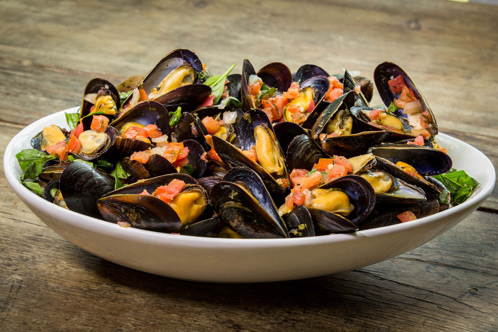A dish of PEI mussels with fresh bruschetta.