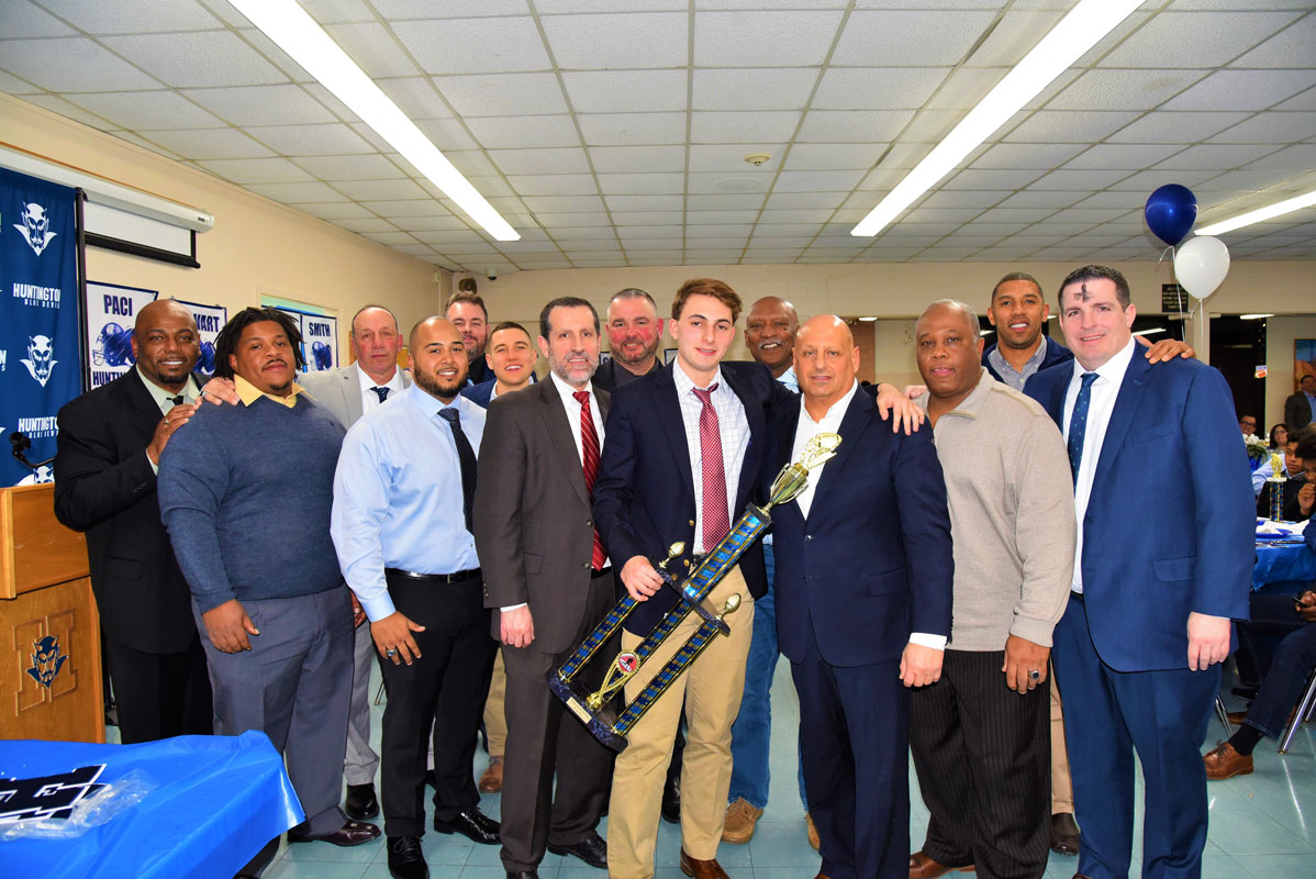 Huntington varsity football MVP John P. Paci with Blue Devil coaches and Superintendent James W. Polansky 