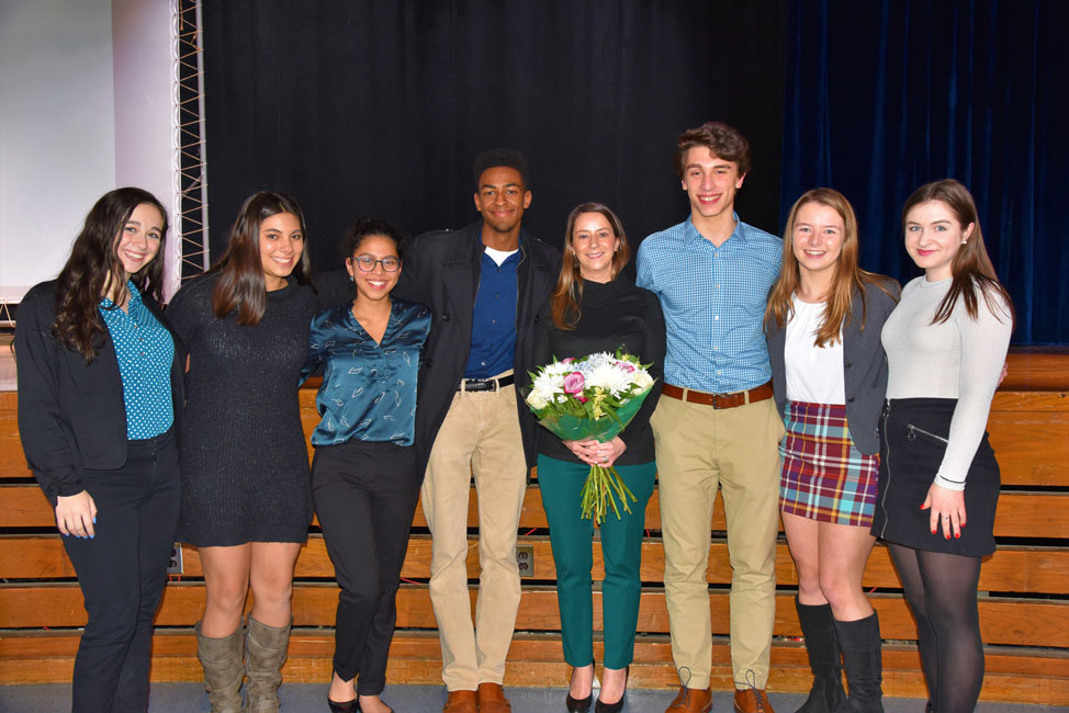 Huntington National History Day club executive board members flank faculty advisor Lauren Desiderio.