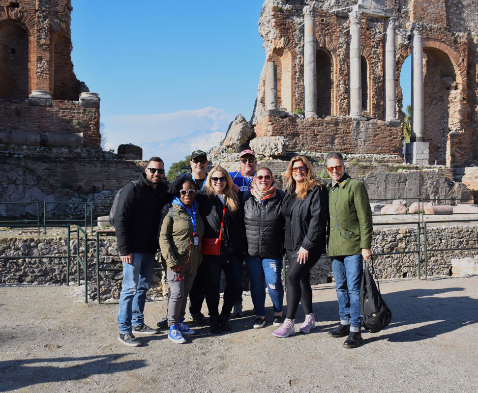The eight adult chaperones at the site of ancient ruins in Italy.