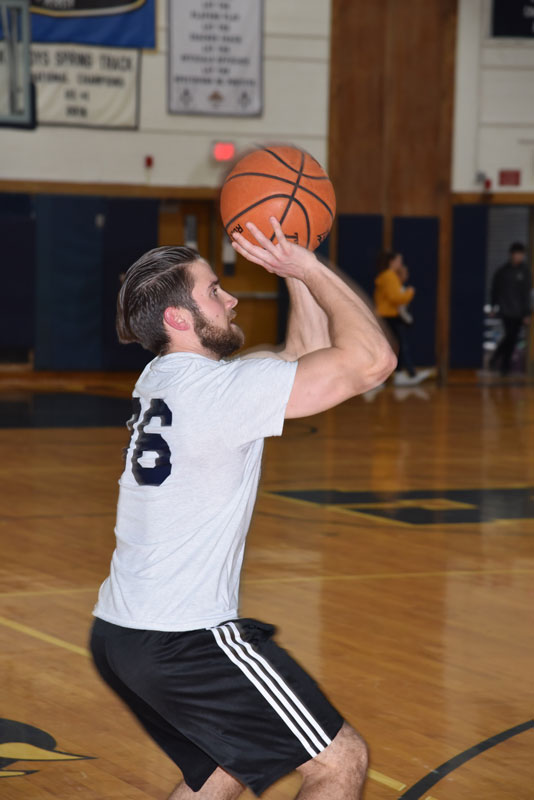 Huntington High School physical education teacher Alex Nelson shows his shooting form.