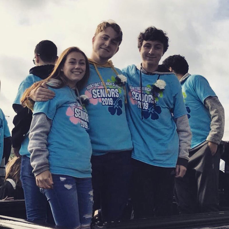 Dominick Stanley is flanked by close friends Meagan Malone and Matthew Quinn during the Homecoming Day parade.