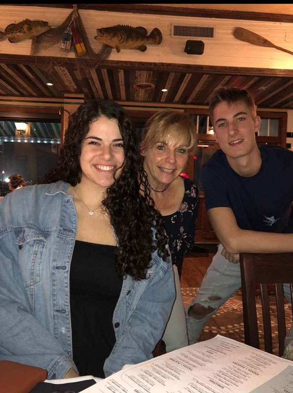 Teacher Suzi Biagi is flanked by juniors Riva Bergman and RJ Moreno in New Orleans.