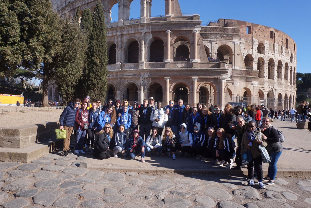 The Huntington traveling party outside the Roman Colosseum.