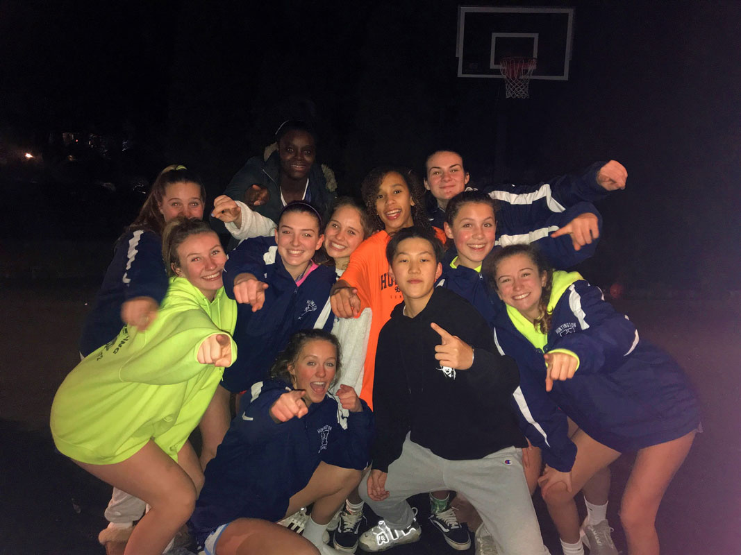 The Huntington girls' basketball team adopted Kris (center) from Hong Kong.
