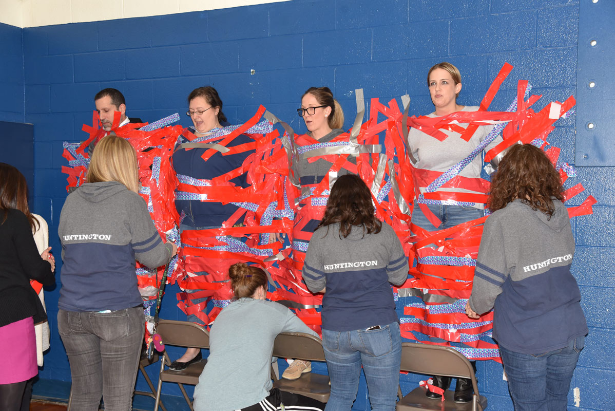 Supt. Jim Polansky and Finley teachers Denise Grodzicki, Jennifer DiMattei and Katherine Kid were taped to the gym wall.