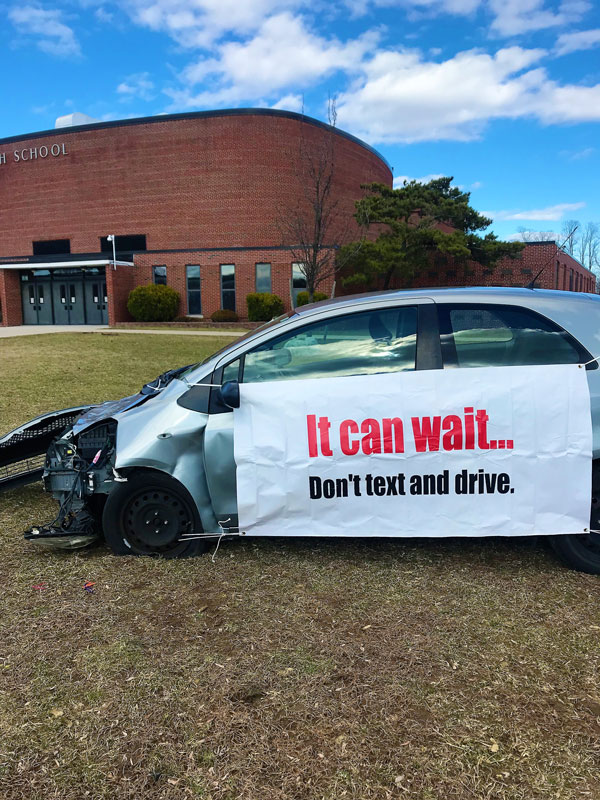 A wrecked car left outside Huntington High School provided a powerful visual statement (2)