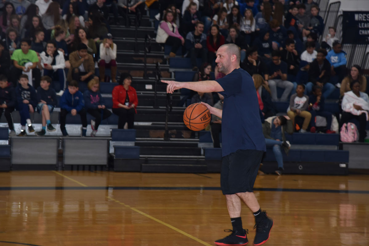 Woodhull School teacher Jason Suarez directs his team.