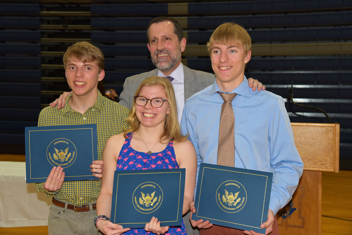 Huntington Superintendent James W. Polansky with seniors Luke, Emma and Jack Farrell.