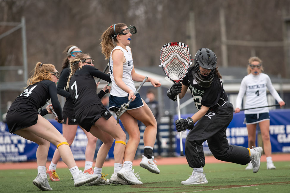 Abby Maichin (in white) is typically double or even triple teamed but still has 35 goals and 16 assists this spring. (Darin Reed photo.)