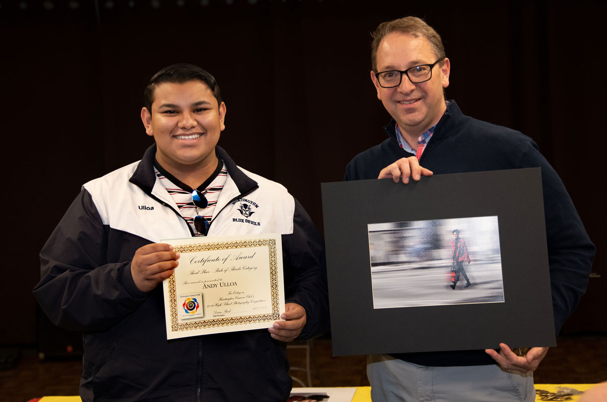 Andy Ulloa with Huntington Camera Club President Darin Reed who is holding the teenager's award winning contest entry.