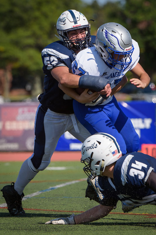 Bryce Criscuola (left) makes the tackle for Huntington.