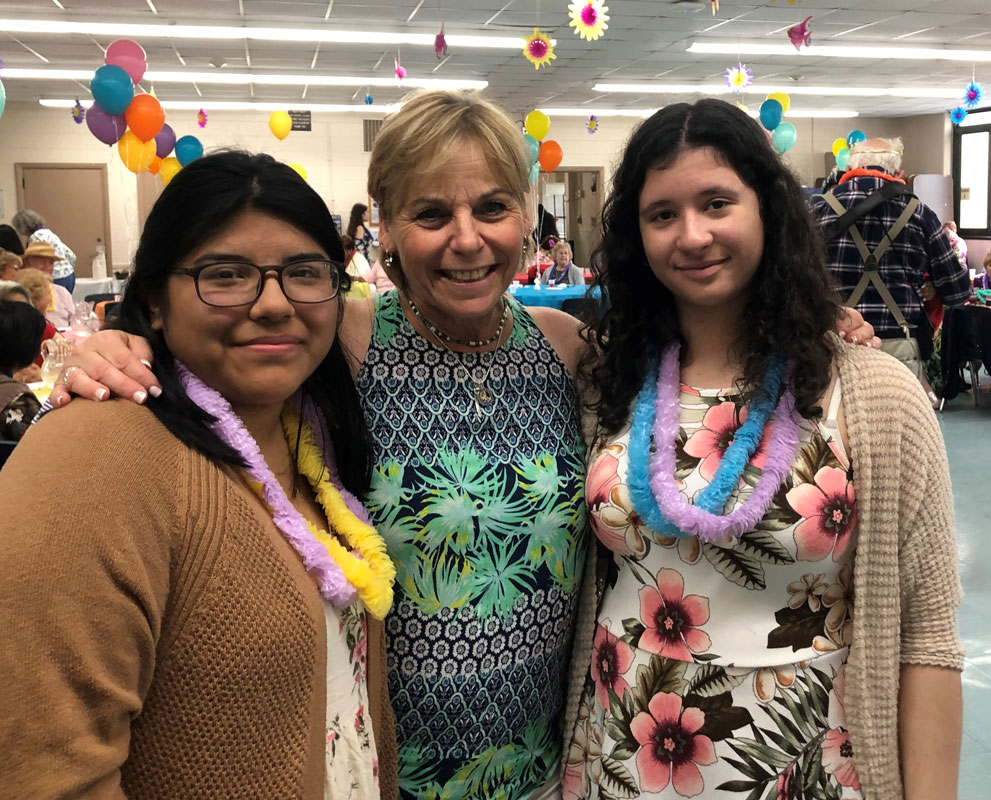 Grandfriends club faculty advisor Suzi Biagi with some of the teenagers who made the senior-senior prom so special.