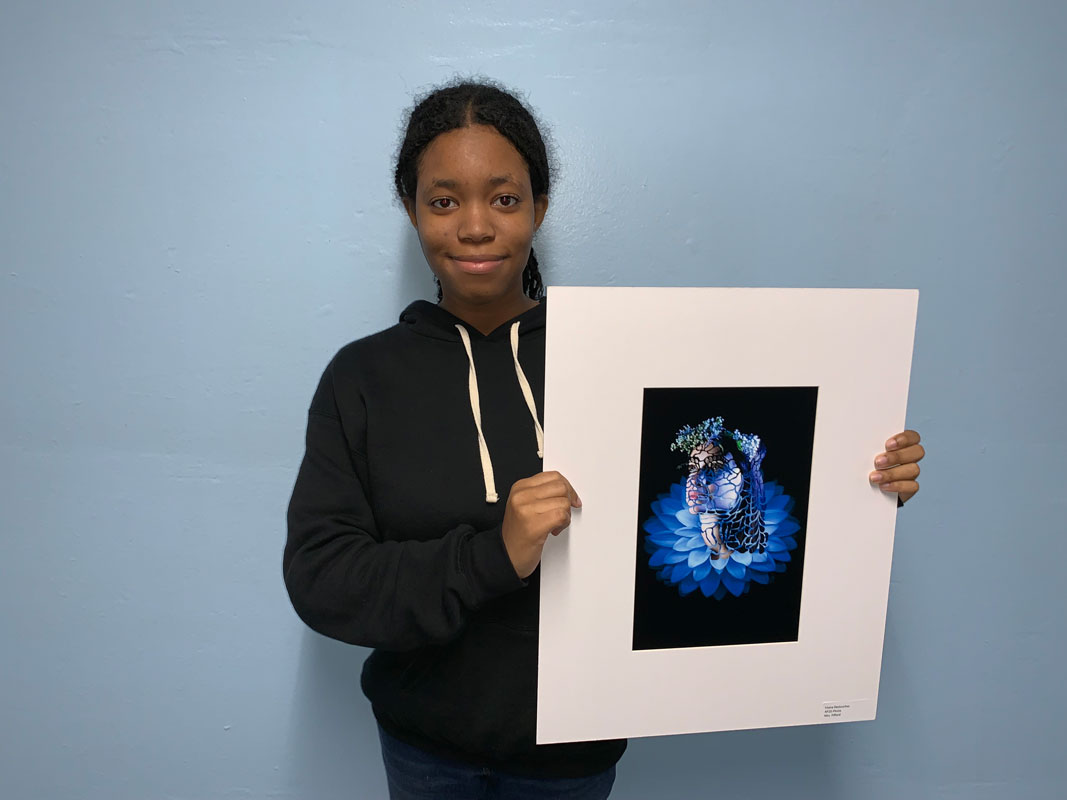 Huntington senior Irtana Deslouches holds one of her award winning pieces.