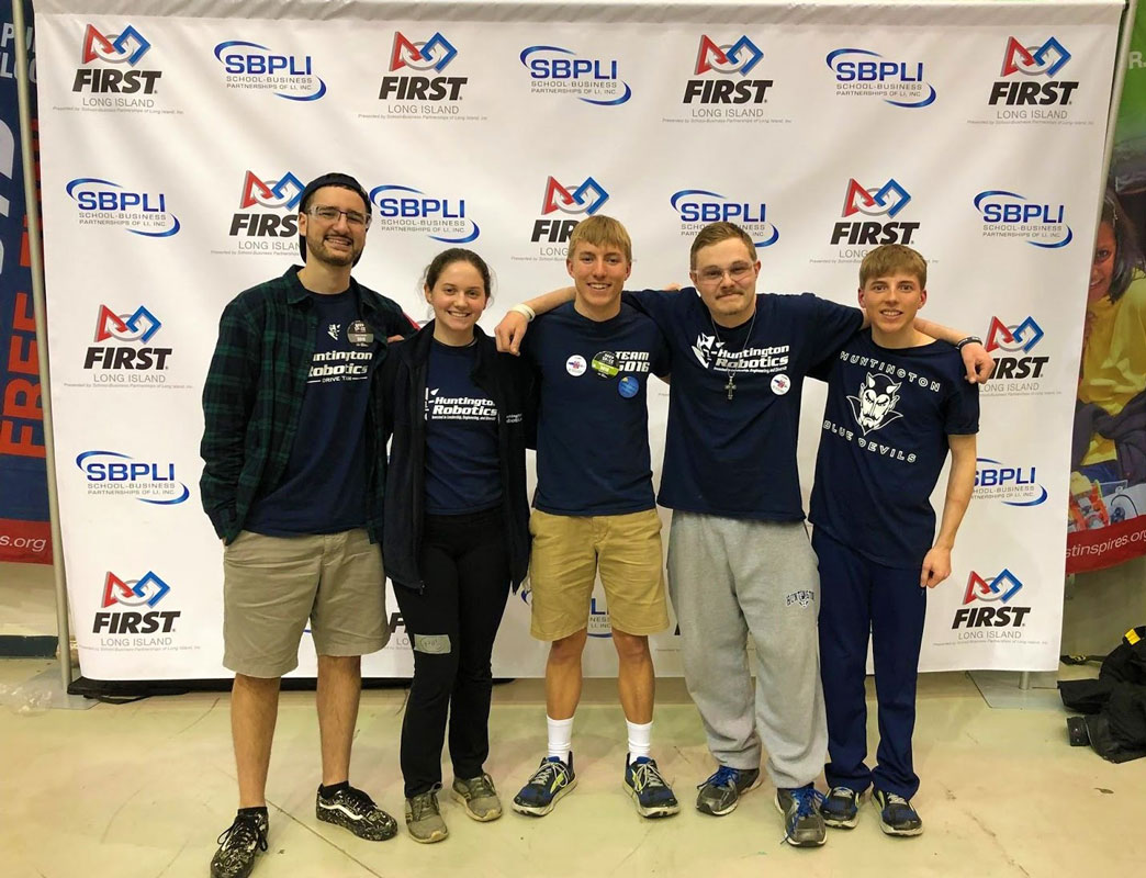 Jack Farrell (center) with fellow Huntington Robotics seniors.