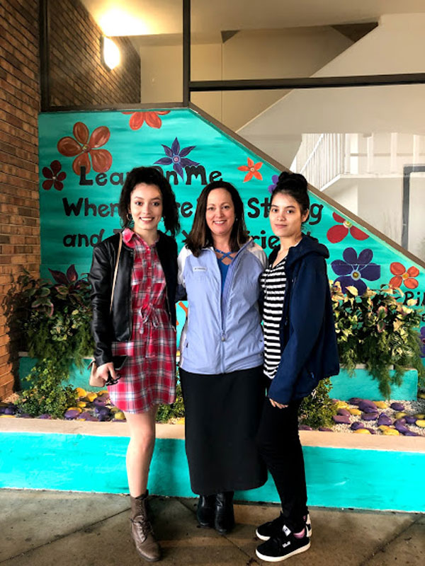 Teacher Eileen Gonzalez is flanked by Ilsi Martinez Euceda and Yessy Bonilla Lainez.