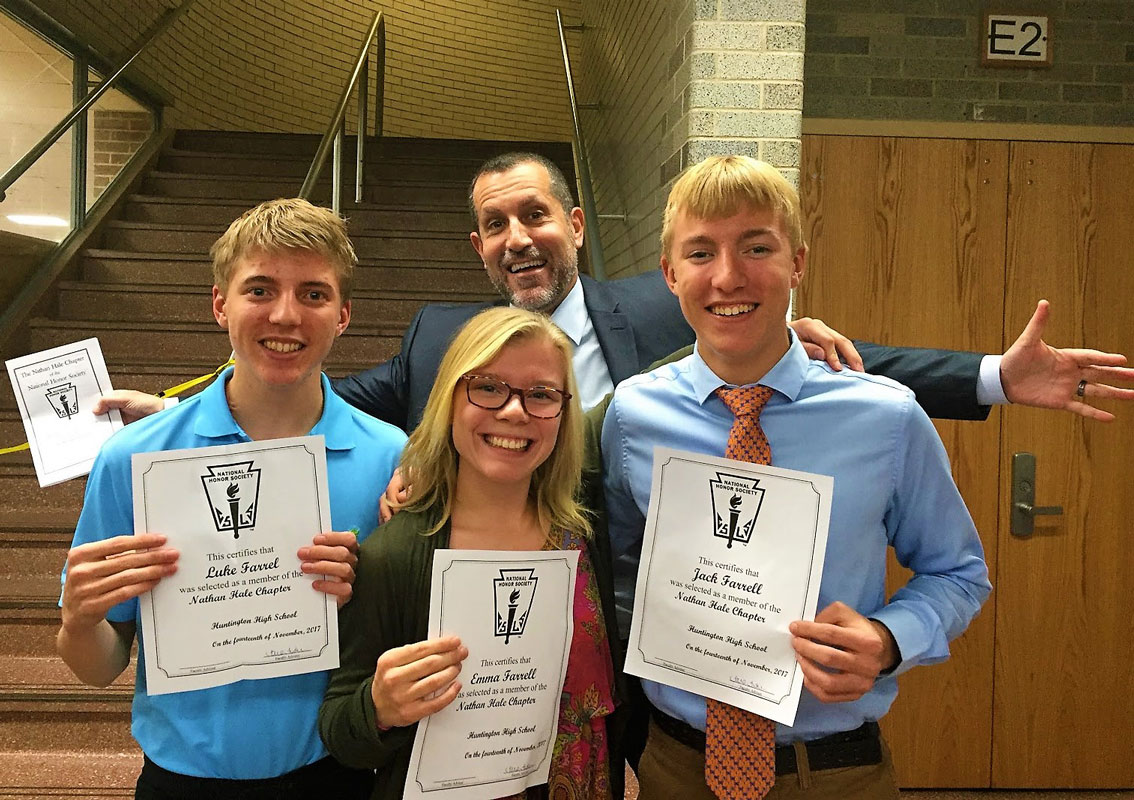 Jack Farrell (right) with his brother, Luke and sister, Emma and Supt. Jim Polansky following  the National Honor Society induction.