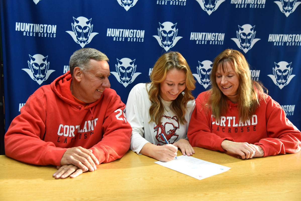 Holly Wright commits to play lacrosse at SUNY Cortland as her parents, Bill and Kathy look on 