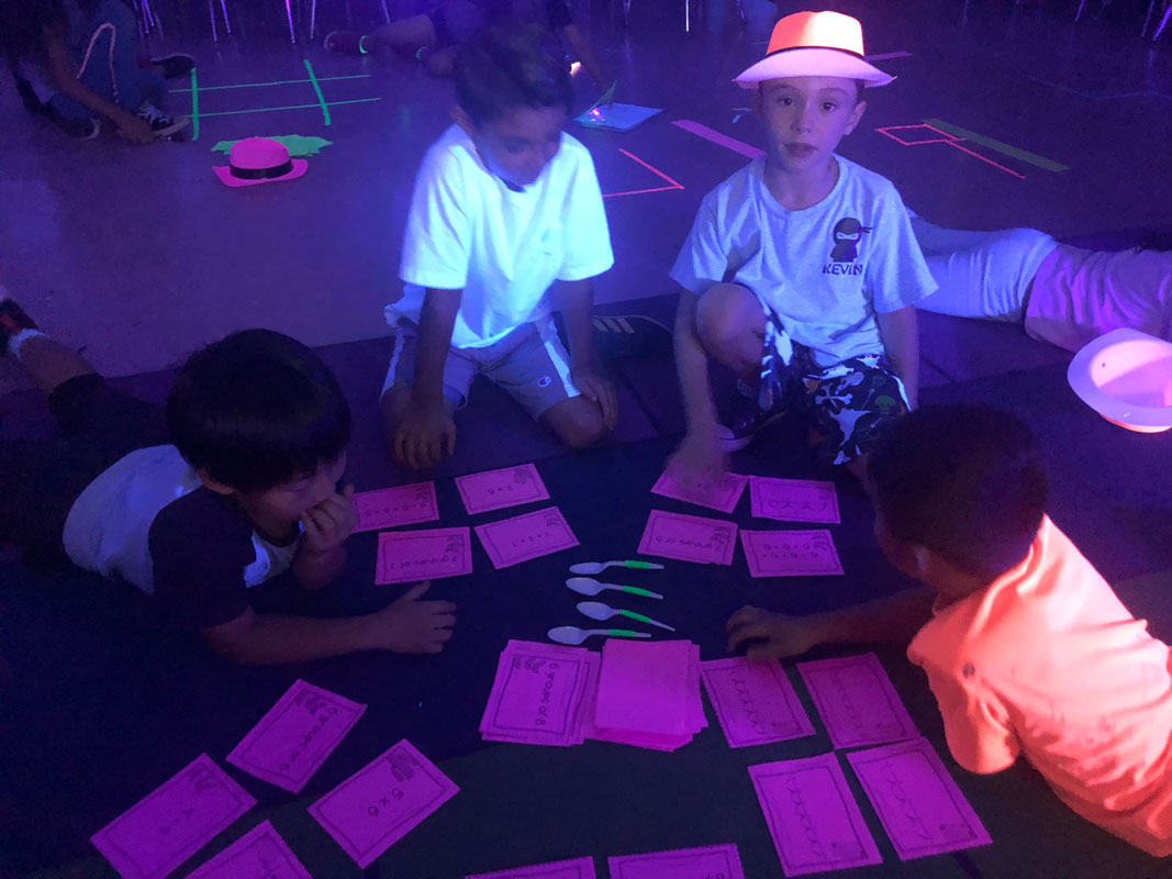 A Flower Hill room was darkened with backdrops that allowed UV lights to shine bright and illuminate the class 