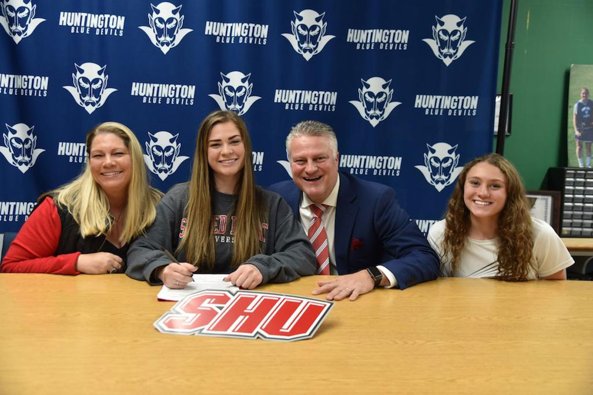 Huntington's Megan Agrillo signed an NCAA letter of intent to play lacrosse at Sacred Heart while surrounded by her family.