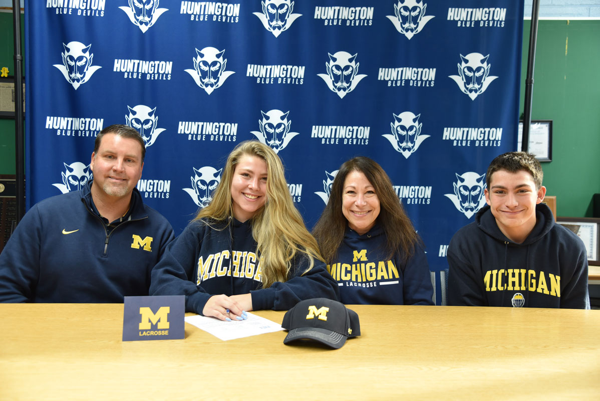Maya Santa-Maria signs as her parents, Anthony and Lisa and brother, Cameron watch.