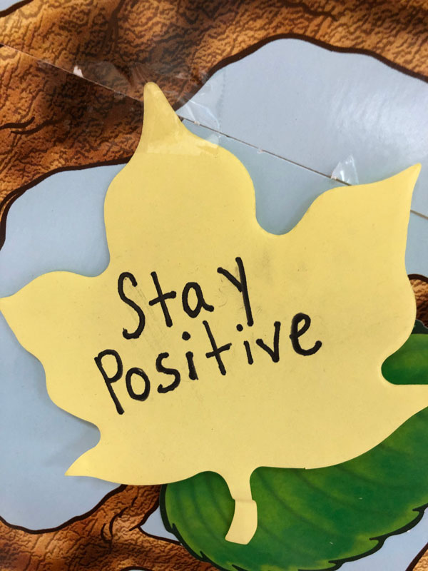 Woodhull students are writing encouraging words and phrases on leaves and posting them on a hallway tree.