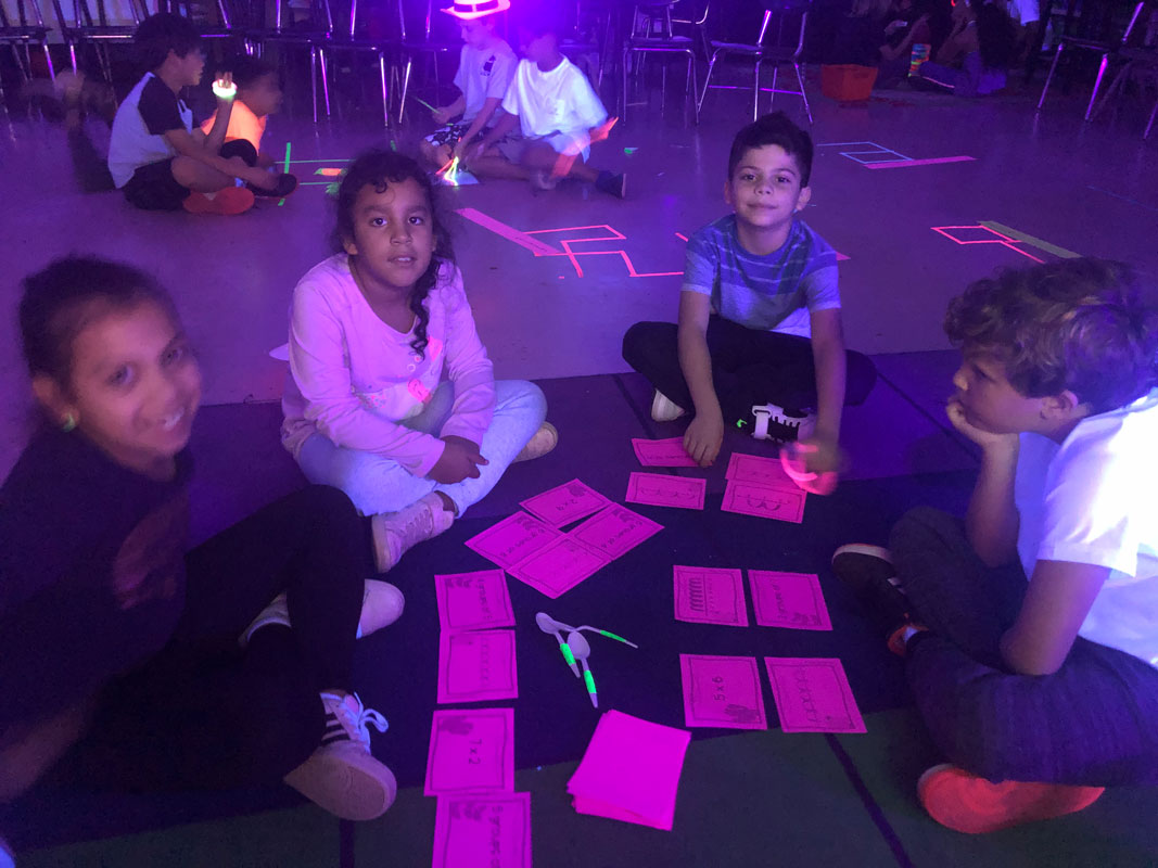 A Flower Hill room was darkened with backdrops that allowed UV lights to shine bright and illuminate the class 