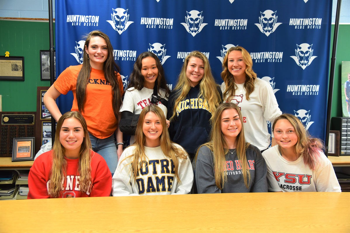 Anna Wickey (back row second from left) with her fellow Huntington seniors who committed to play sports.
