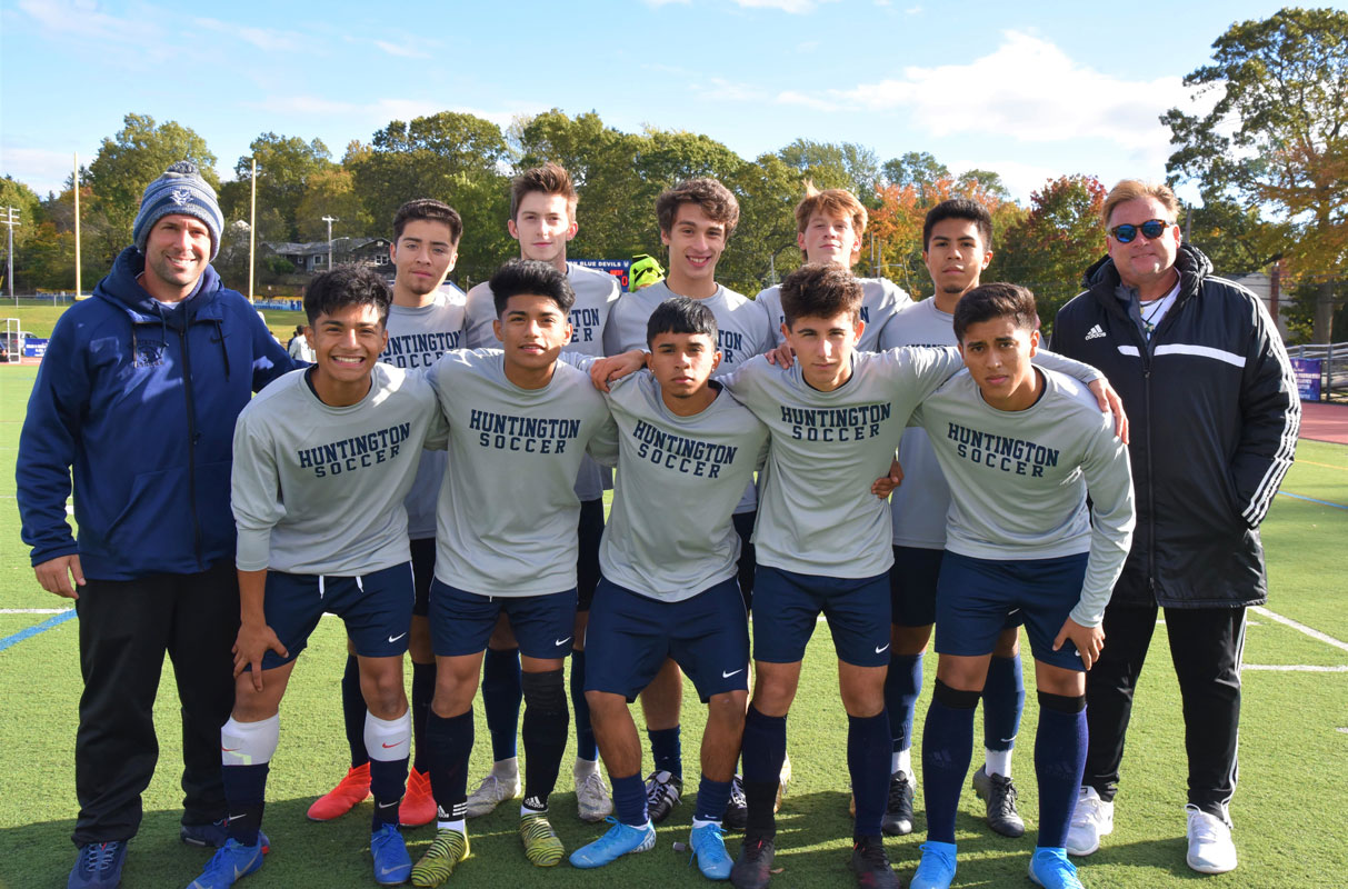 Coaches Jason Suarez and John Pagano with their 10 seniors at Blue Devil Stadium on Senior Day.