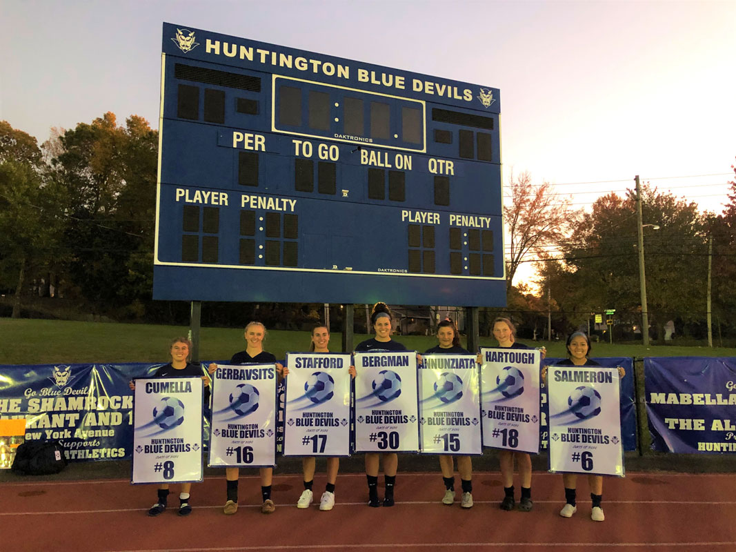 The Blue Devil girls' soccer seniors with their banners following the game against Longwood.