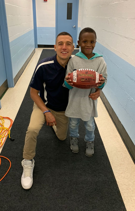  Huntington High School football coach James G. Byrnes with Flower Hill's Jeremiah Lacen. 