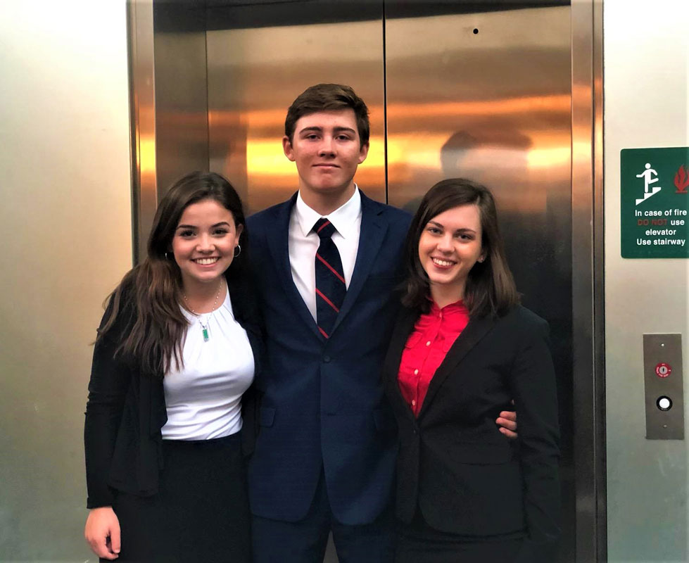  Huntington High School Virtual Enterprise company CEOs Taylor Case, Charles O'Rourke and Abby Holmes at LIU Post for the elevator pitch competition. 