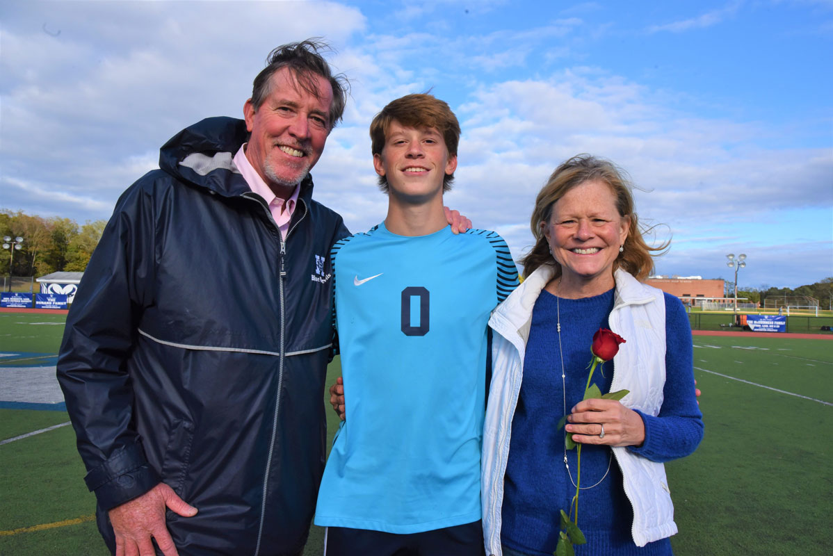 Huntington goalie Cole Pillion is flanked by his parents, Tim and Jean on Senior Day at Blue Devil Stadium.