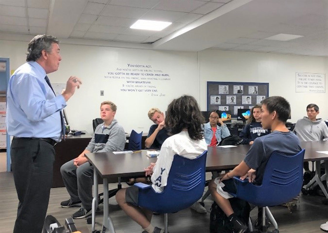 Businessman Jamie Proctor makes a point as Virtual Enterprise class students listen.