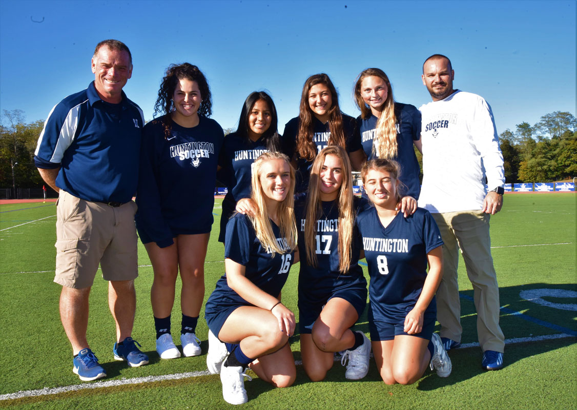 Coaches John Walsh and Vinny Tannazzo with Huntington's seven spectacular seniors