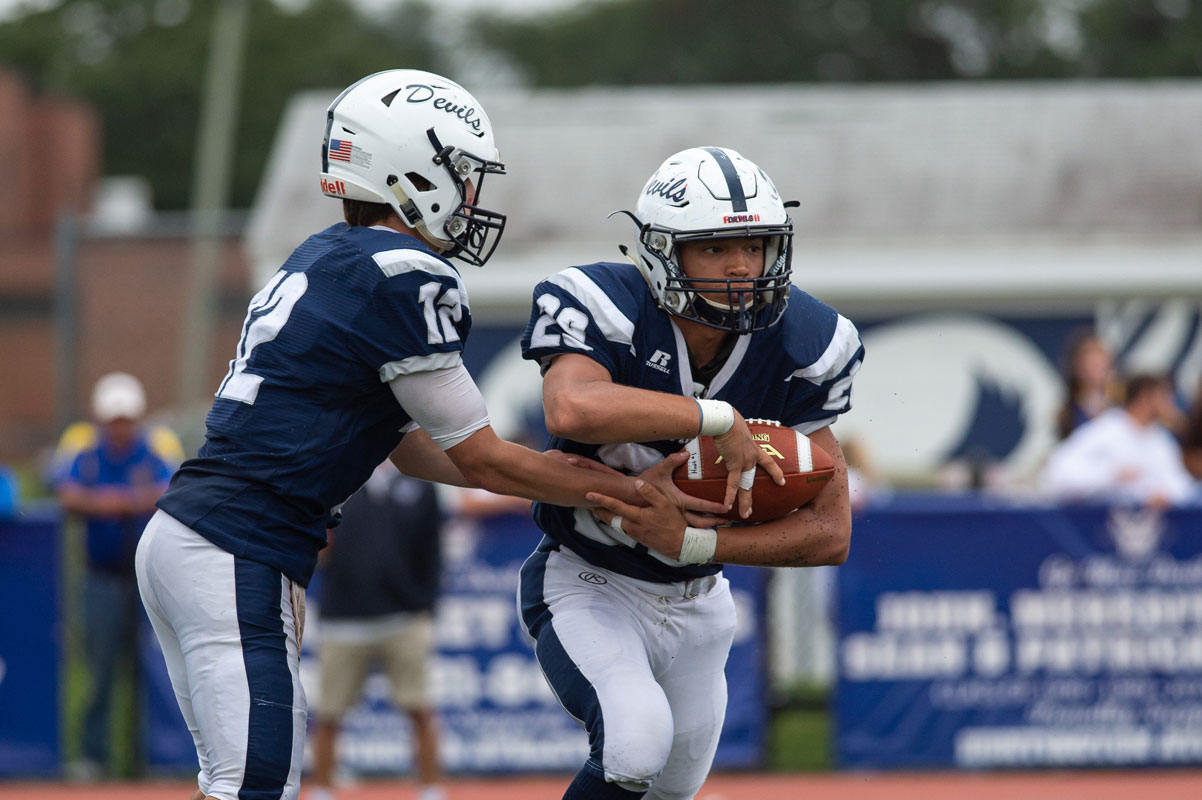 Lex Colato takes the handoff from quarterback Torin Bograd. (Darin Reed photo)