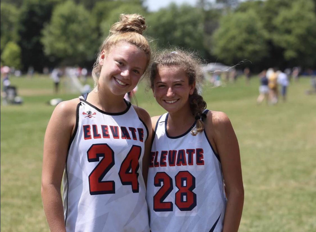 Huntington junior Alexa Amorison with lacrosse teammate Leah Hansen.