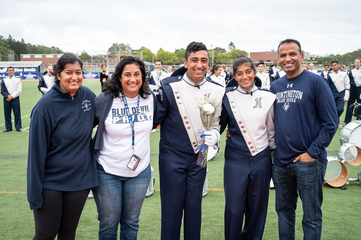 Zubair Ali is flanked by his family at last fall's marching band home show. (Darin Reed photo.)