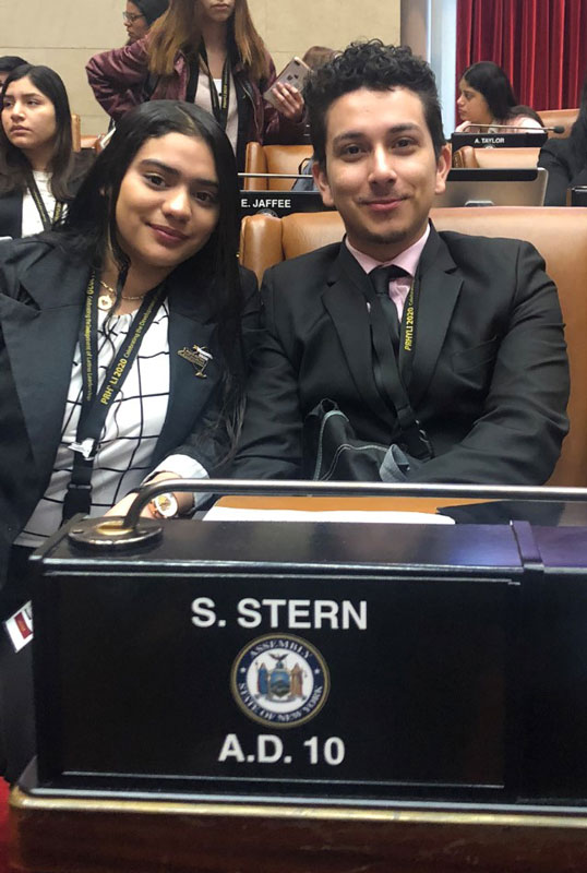 Junior Yolani Cabrera and senior Erlyn Flores Reyes in the State Assembly chamber.
