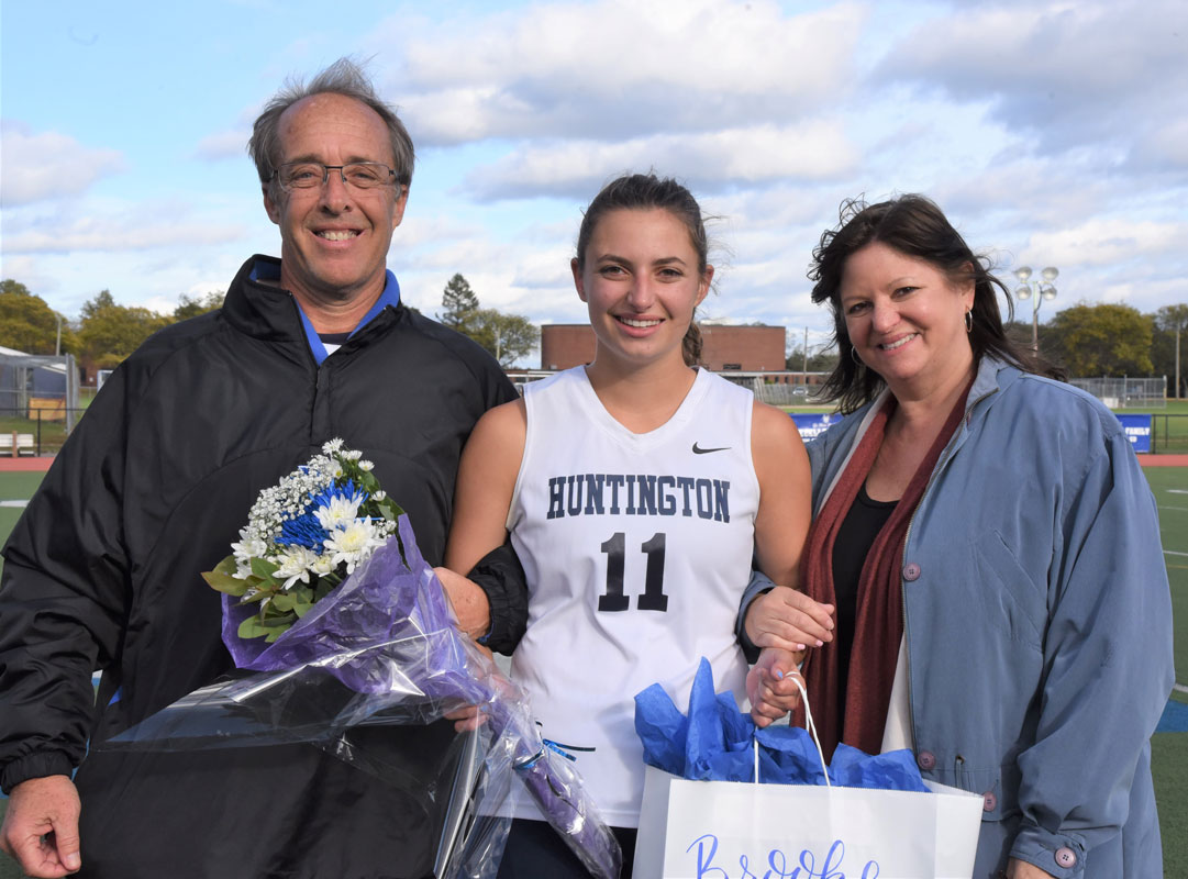 Brooke Biernacki with her parents on Huntington field hockey Senior Day.