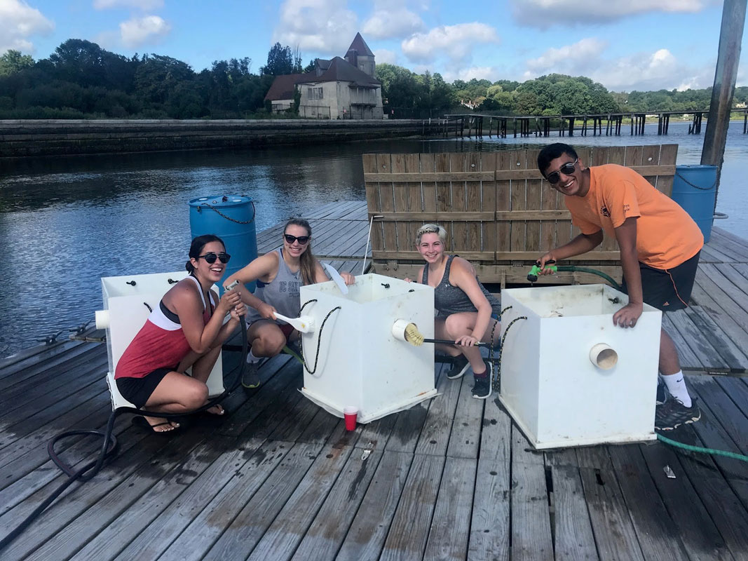 Zubair Ali (right) with research partners on Huntington Harbor.