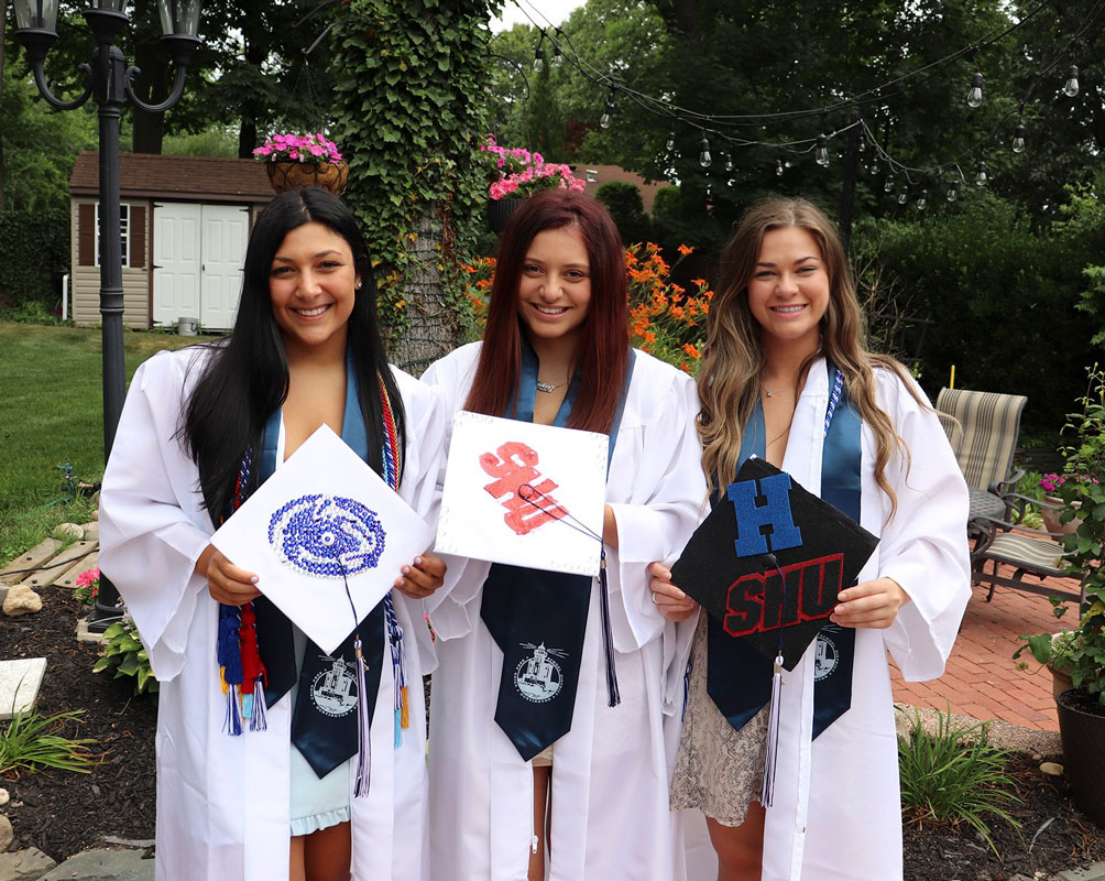 Mia Redick (center) is flanked by fellow graduates Lena Annunziata and Megan Agrillo. 