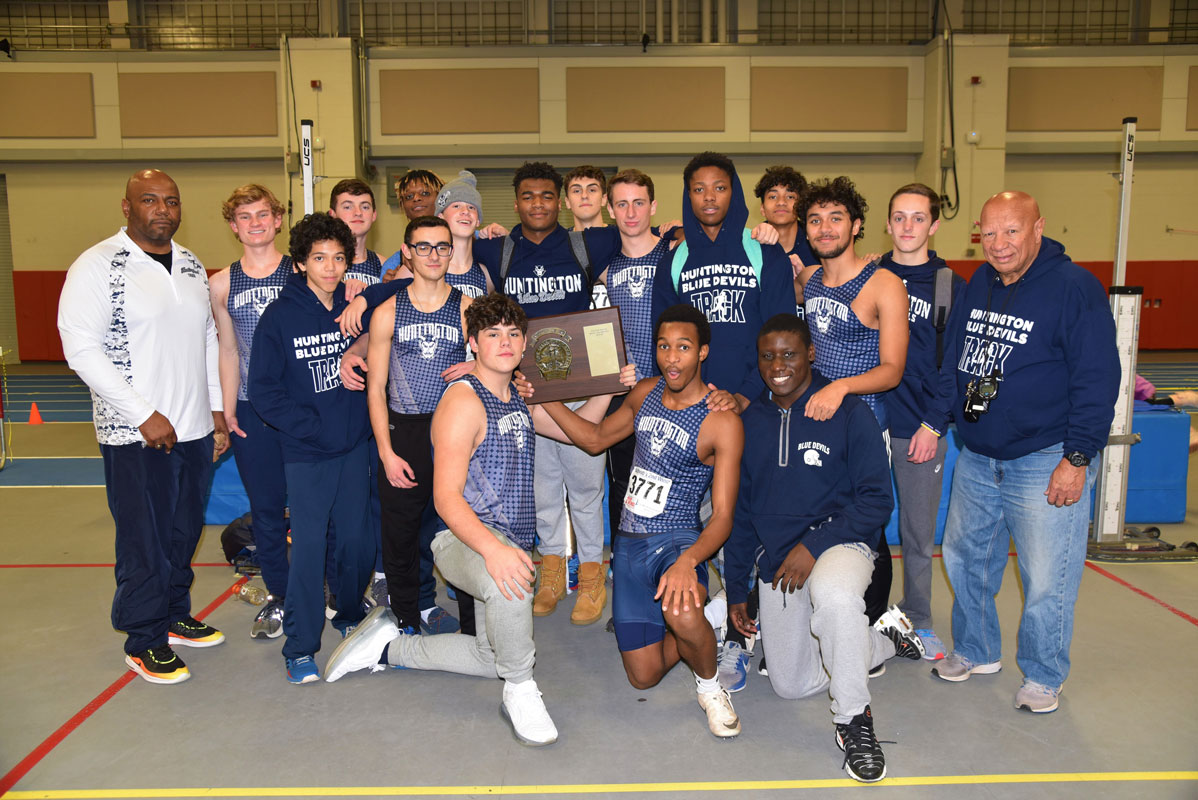 The Huntington boys' indoor track team and coaches with the county championship plaque 