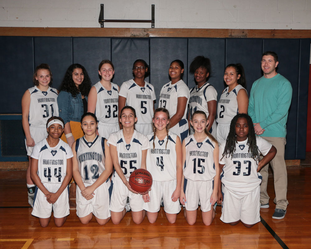 The Huntington junior varsity girls' basketball team with head coach John Romano.