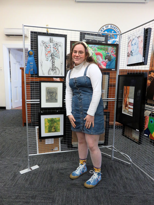 Huntington senior Josie Fasolino with her artwork on display.